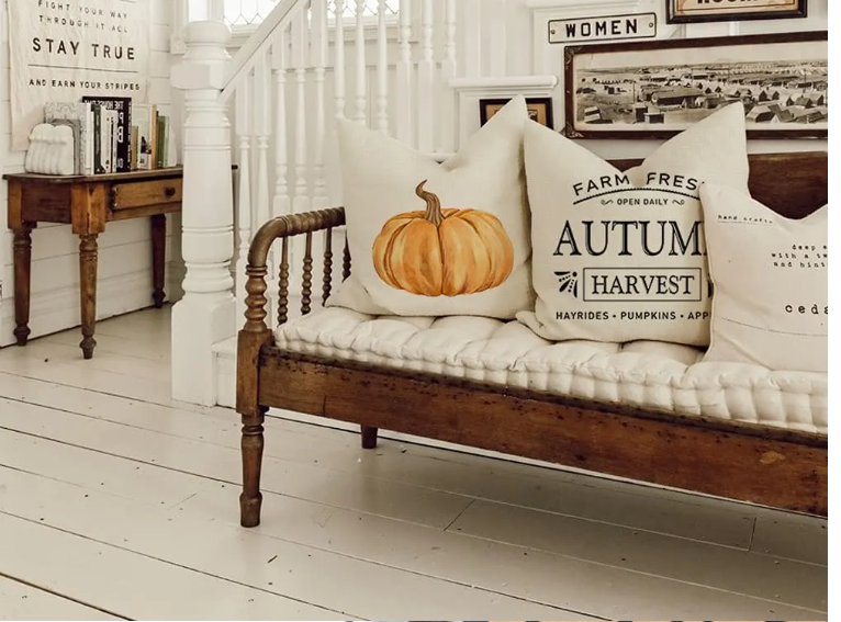 Our Autumn Farmhouse pillow covers displayed on an entryway bench