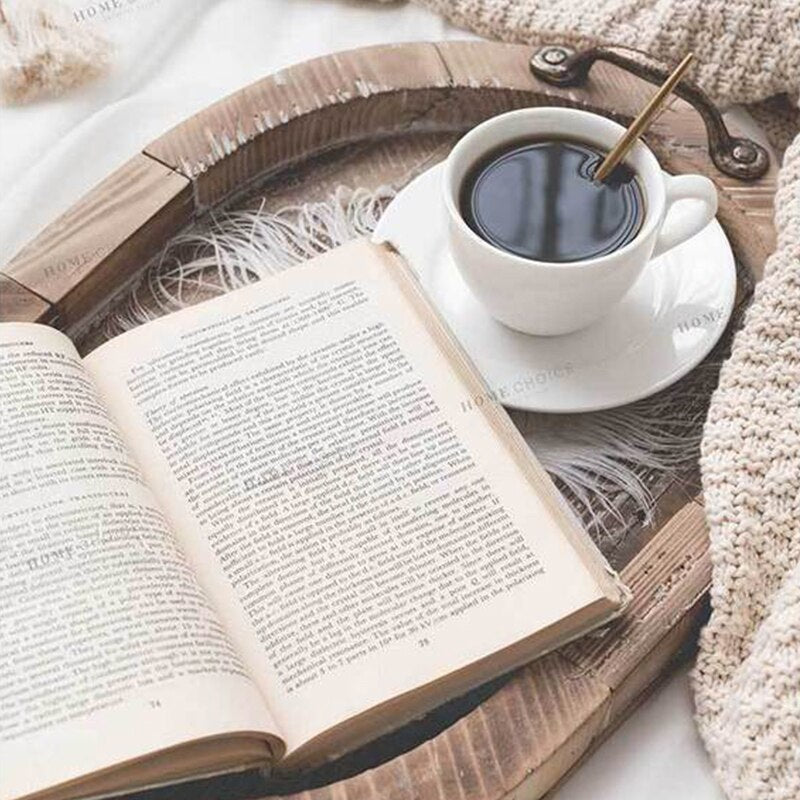 Rustic Oval Wood Tray styled for the living room or bedroom complete with a book and a cup of coffee.