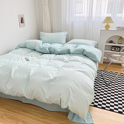 Simply Classic Duvet Cover Set 3 or 4 PC set. Easy to care for microfiber with waffle weave design on one side . Totally reversible. Shown in light blue and styled in a bedroom.