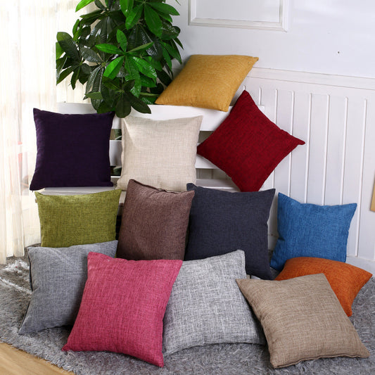 Simply Linen Pillow Covers in the 13 colors available stacked in a living room.
