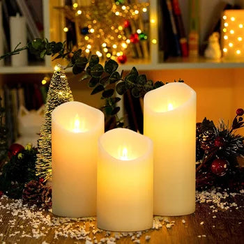 3 Pc Flameless Pillar Candles, all lit up with a Christmas background of twinkle lights and holly.  Comes with remote control.  Batteries not included.