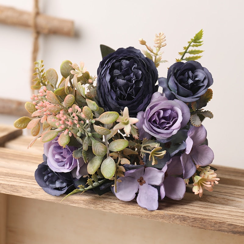 Handmade artificial silk peonies and roses bouquet. Light mauve to dark purple blooms with greenery.