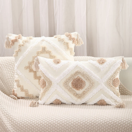 God's Eye Tufted Pillow Cover in creamy neutrals and another design with creamy neutrals and black.