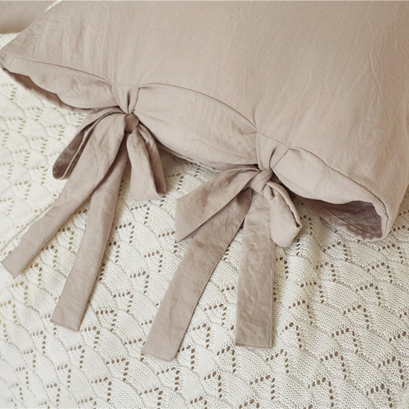 Bowtie Lace up Duvet Cover set showing the detail of the ties that are on one side of the pillow sham (cover) that are included in this set.