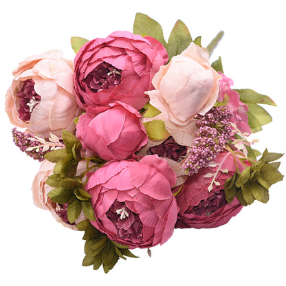 1 bunch of soft and darker pink European Silk Peonies complete with muted green leaves.