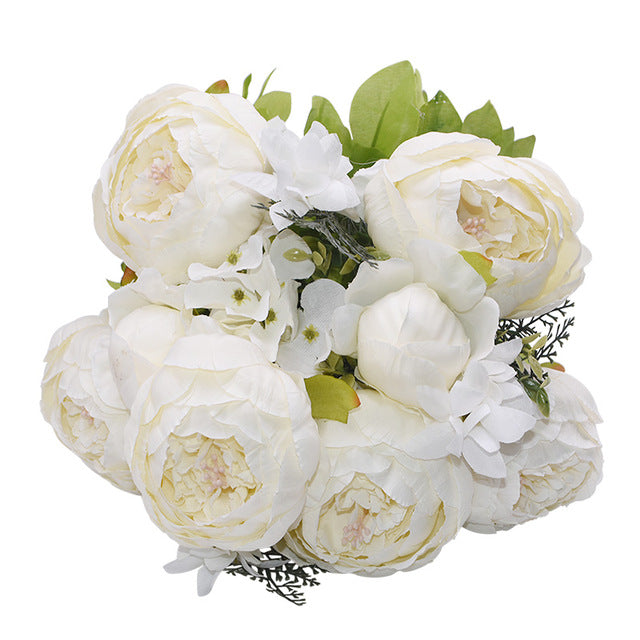 1 bunch of creamy white European Silk Peonies complete with muted green leaves.