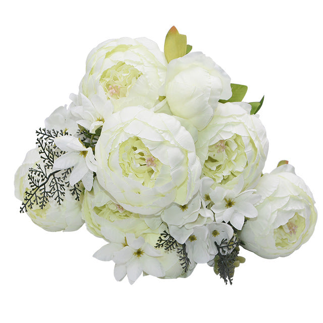 1 bunch of white European Silk Peonies complete with muted green leaves.