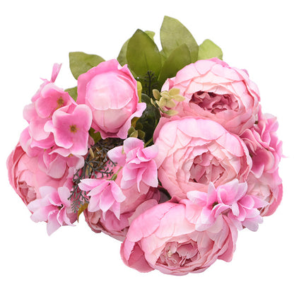 1 bunch of bright pink European Silk Peonies complete with muted green leaves.