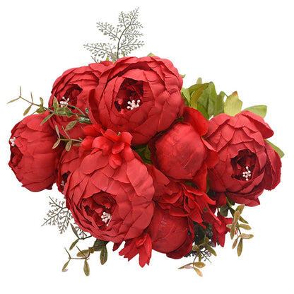 1 bunch of very soft red European Silk Peonies complete with muted green leaves.