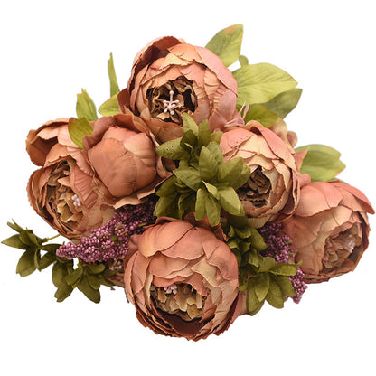 1 bunch of very, very light , almost coppery colored European Silk Peonies complete with muted green leaves.