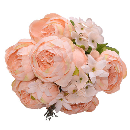 1 bunch of light peach colored European Silk Peonies complete with muted green leaves.