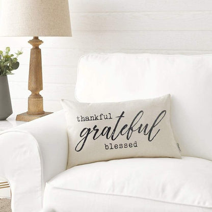 Autumn Farmhouse Pillow Cover.  Natural texture of linen look fabric depicting country charm.  Text is black  and 2 pairings of font styles which are "typeset" and "brushed lettering" on a warm white background. Thankful Grateful Blessed".