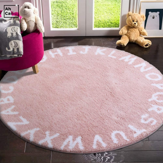 Soft Round Alphabet Rug in pink with the alphabet in white around the outside edge of the rug.  Non-skid back but we do recommend that a non-skid backing be placed under it if using on laminate, hardwood, or tile.