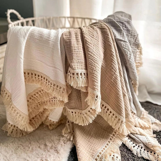 Bamboo and Cotton Muslin Baby Swaddle Blanket.  Very soft in plain colors such as khake, blue, gray, pink, and more.  Also, printed designs , all complete with a fringed edging.  2 sizes available 47"X40" and 31"X25".