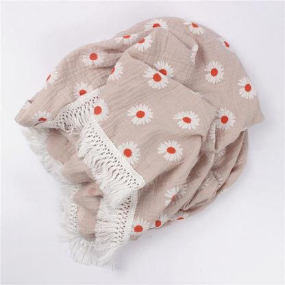 Bamboo and Cotton Muslin Baby Swaddle Blanket.  Very pale blush pink with daisies randomly scattered over it.  A beautiful creamy white fringed edging completes this design.  Available in 2 sizes 47"X40" or 31"X25".